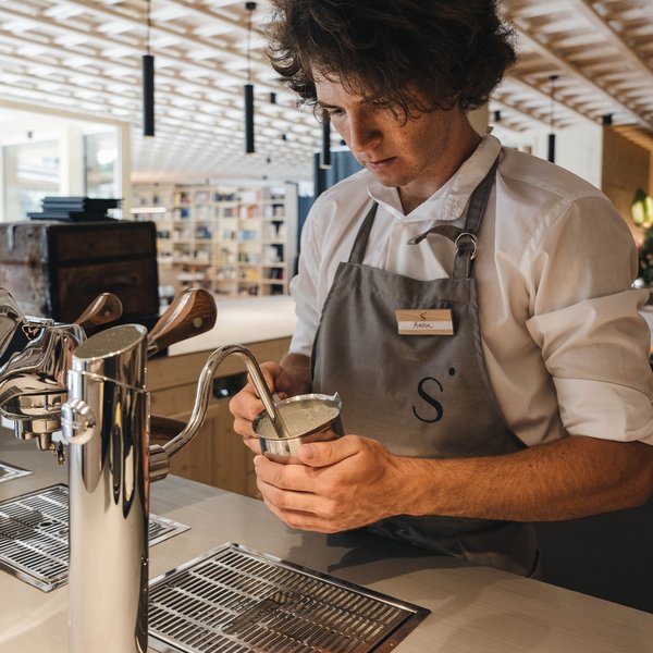 Sensoria Soulmates – Creating Memories of Bliss Barista frothing milk using an espresso machine in a cafe