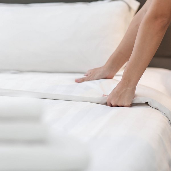 Sensoria Soulmates – Creating Memories of Bliss Person making a clean white bed in a bedroom