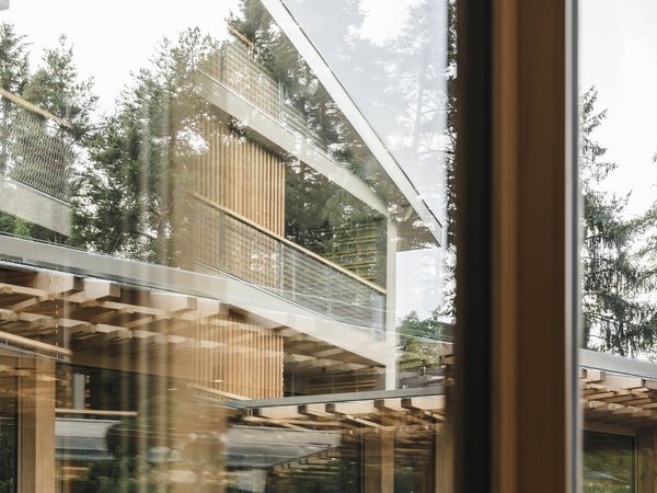 Sensoria Soulmates – Creating Memories of Bliss Modern wooden architecture with large windows and trees in the background