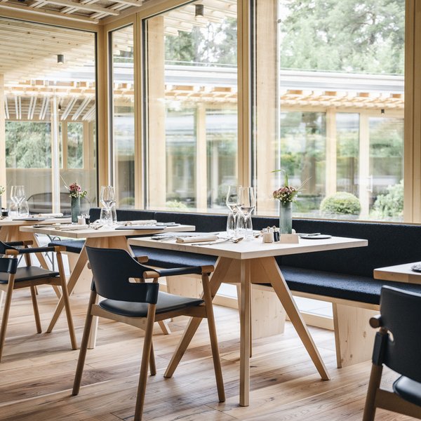 Sensoria Soulmates – Creating Memories of Bliss Modern restaurant with wooden furniture and large windows overlooking greenery