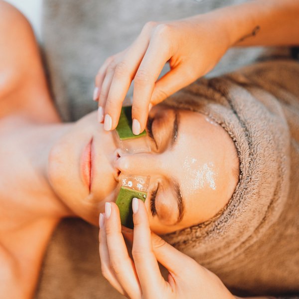 Sensoria Soulmates – Creating Memories of Bliss Woman receiving facial treatment with aloe vera gel on eyes