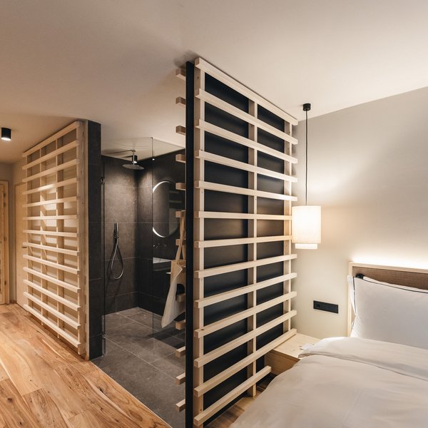 Sensoria Soulmates – Creating Memories of Bliss Modern hotel room with wooden partitions and open bathroom area