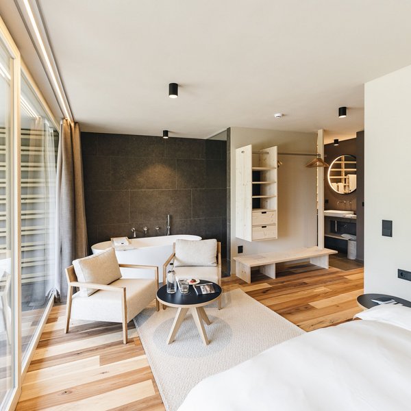 Sensoria Soulmates – Creating Memories of Bliss Modern hotel room with bathtub, shower, and seating area