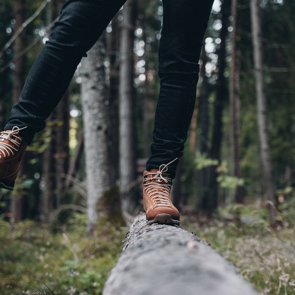 Sensoria Soulmates – Creating Memories of Bliss Person balancing on a tree trunk in the forest wearing brown hiking boots